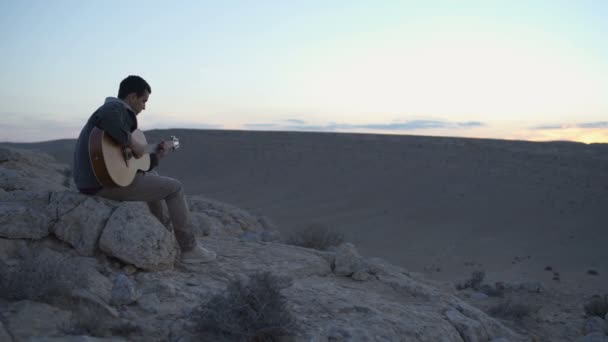 Young Musician Plays Tune Desert Sunset — Stockvideo