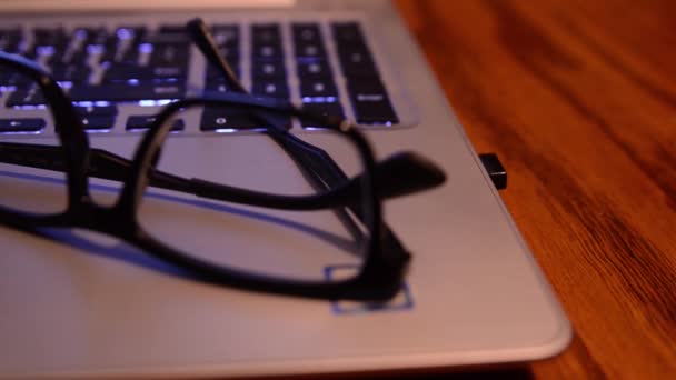 Slider Shot Panning Right Left Glasses Resting Top Laptop Computer — 图库视频影像