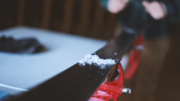 Person Scrapes Wax Skis Ironing — Stock video