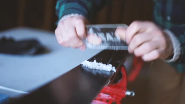 Slow Motion Shot Person Scraping Wax Skis — Vídeo de stock