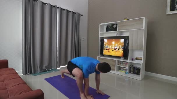 Guy Stretching Floor His Living Room Front Television While Moves — Stock Video