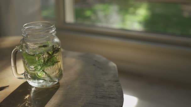 Herbal Tea Glass Mug Sitting Wooden Table Window — Video Stock