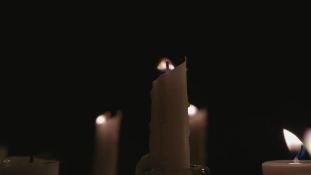 Extreme Close White Candles Lit Black Background One Gets Blown — Video Stock