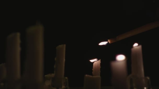 Extreme Close White Candles Lit Black Background One Candle Lighting — Videoclip de stoc