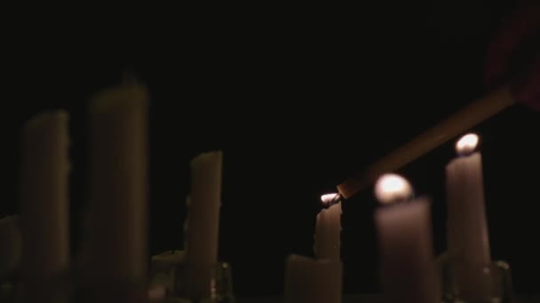 Extreme Close White Candles Lit Black Background One Candle Lighting — Stock Video