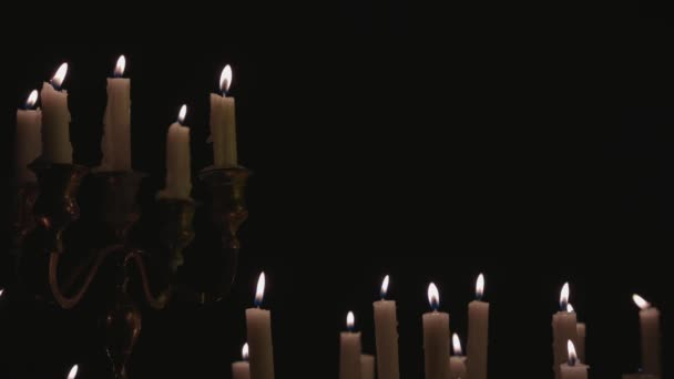 Group White Candles Some Candelabra Lit Running While Great Background — Stockvideo