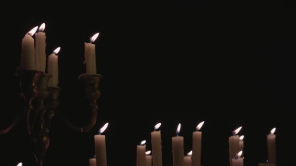 Group White Candles Some Candelabra Lit Running While Light Panning — Stock video