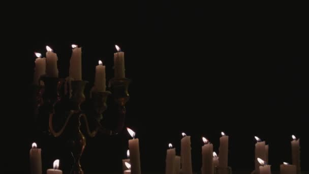 Group White Candles Some Candelabra Lit Running While Light Panning — Stock video