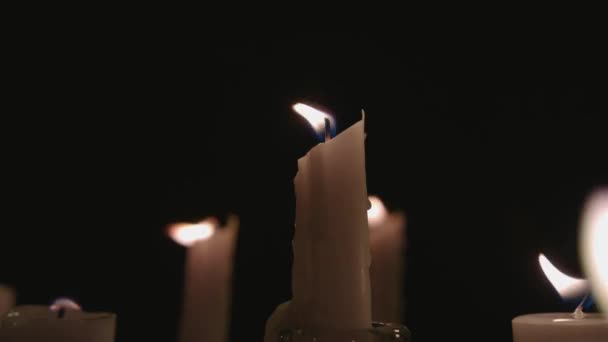 Extreme Close White Candles Lit Black Background One Gets Blown — Stockvideo