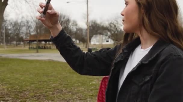 Steadicam Shot Gorgeous Brunette College Student Using Her Smart Phone — Stock video
