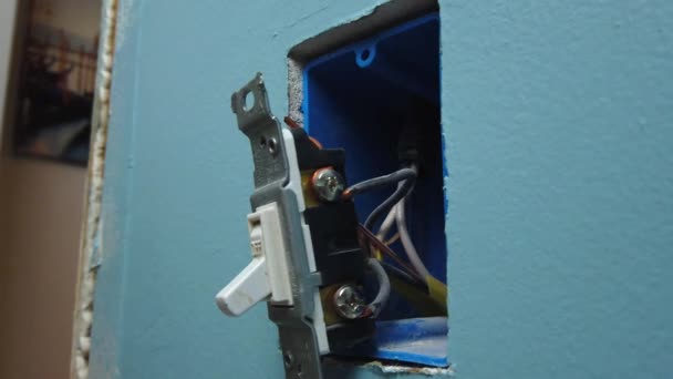 Pulling Switch Out Wall Box Unscrewing Removing Two Wires — ストック動画
