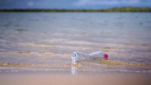 Plastic Bottle Washed Beach Small Waves Floats Away Boat Passes — Stock Video