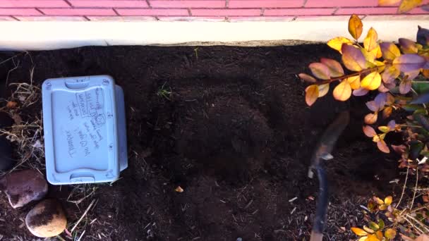 Digging Hole Dispersing Dirt Ground Flower Garden While Plastic Case — Vídeo de stock