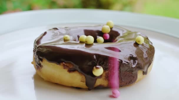 Yellow Pink Sprinkles Falling Chocolate Cream Donut Close — Stockvideo