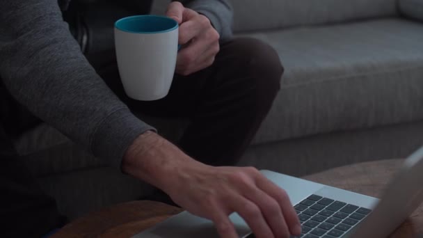 Man Works Computer While Holding Mug Home — Stock video