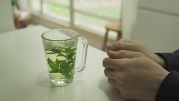 Man Trying Stay Warm Hot Herbal Tea House — Stock Video