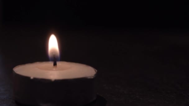 Lit Candle Flickers Dark Background — Wideo stockowe