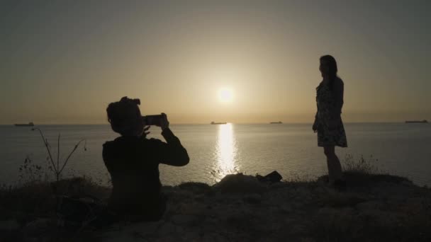 Одна Дівчина Фотографує Іншу Дівчину Телефоном Морі Вид Захід Сонця — стокове відео