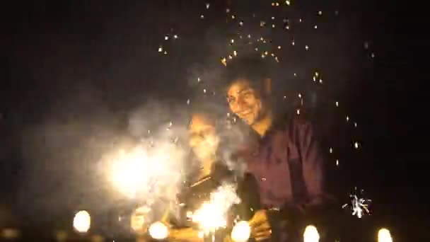 Young Couple Holding Fire Sparkle Cracker Celebrating New Year Diwali — Vídeos de Stock