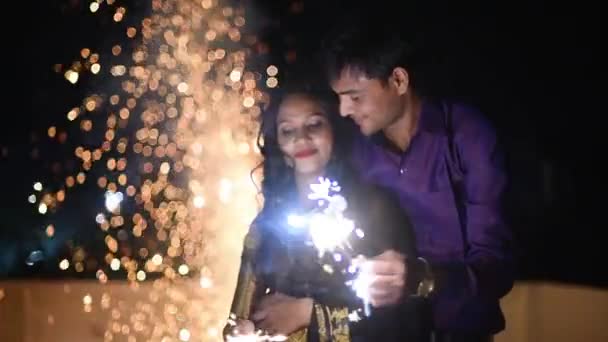 Young Couple Holding Fire Sparkle Cracker Celebrating New Year Diwali — Stock Video