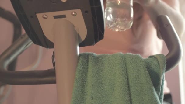 Woman Exercise Machine Drinking Water — Vídeo de Stock