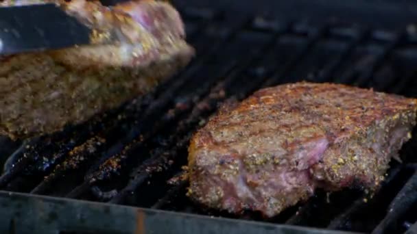 Pair Meat Tongs Turn Nearly Cooked Juicy Rib Eye Steak — Video Stock