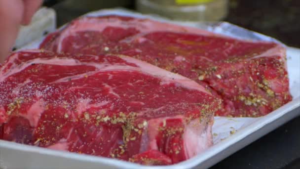 Hand Pours Salt All Rib Eye Steak — Vídeo de Stock