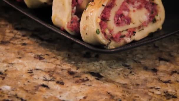 Homemade Pepperoni Roll Italian Stromboli Sliced Displayed Black Plate Slider — Stockvideo