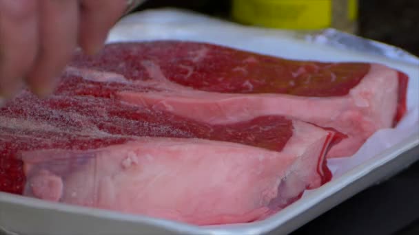 Hand Pours Salt All Raw Rib Eye Steak — Video Stock