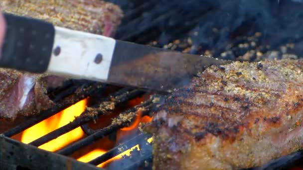 Pair Meat Tongs Side Two Nearly Cooked Juicy Rib Eye — Videoclip de stoc