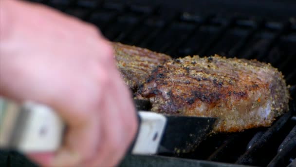 Pair Meat Tongs Turn Nearly Cooked Juicy Rib Eye Steak — Video Stock