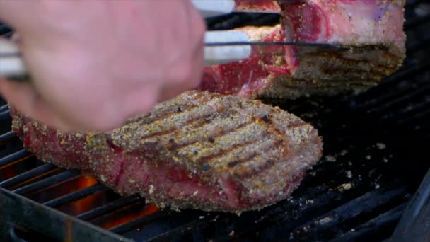 Pair Meat Tongs Lift Nearly Cooked Juicy Rib Eye Steak — Stok Video