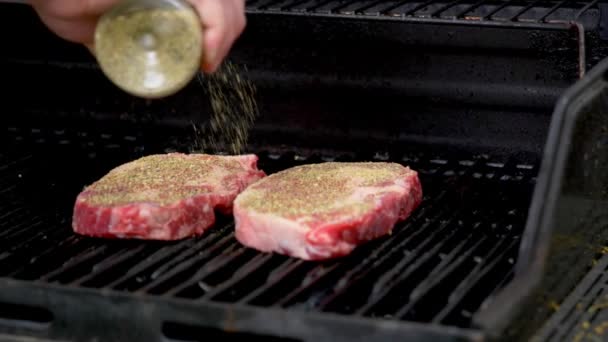Putting Spices Two Rib Eye Steaks Slow Motion — Video