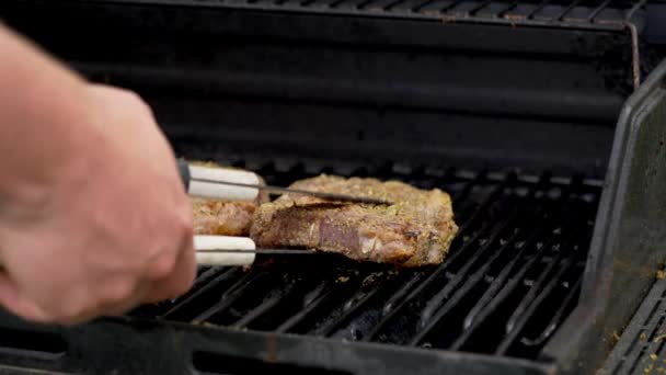 Two Raw Rib Eye Steaks Cooking Grill One Gets Flipped — Stock video