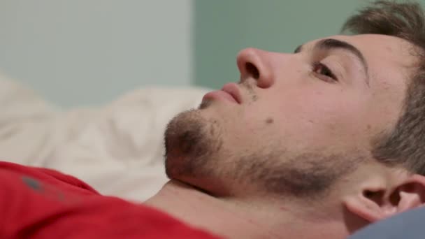 Man Lying Bed Staring Front Him Looking Concerned — Stock Video