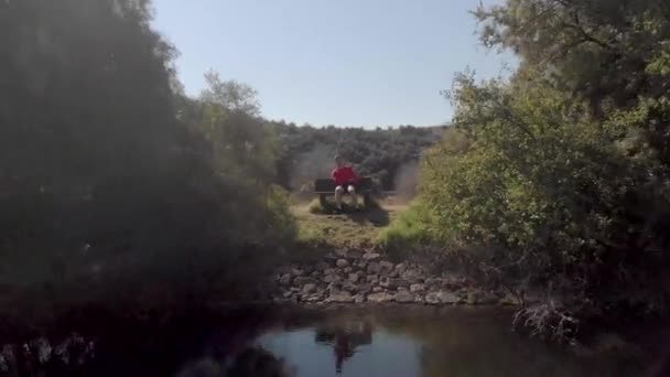 Aerial Reverse Shot Man Sitting Bench Quiet Lake — 图库视频影像