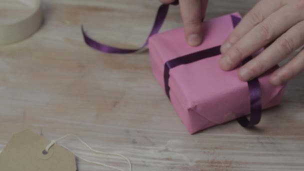 Woman Tying Ribbon Bow Wrapped Gift — Vídeos de Stock