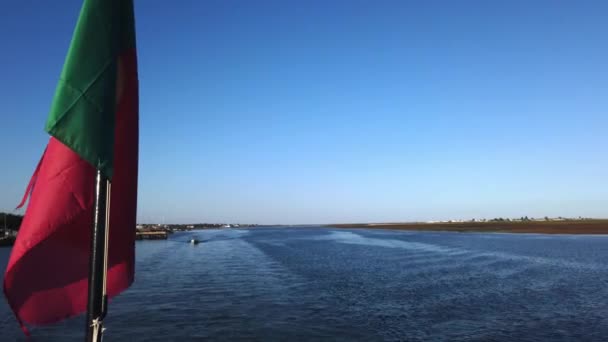 Portuguese Flag Hangs Foreground Ferry Navigating Ria Formosa Olhao Portugal – stockvideo