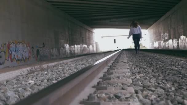 Young Woman Walks Train Tracks Tunnel Full Graffiti Slow Motion — Stock Video