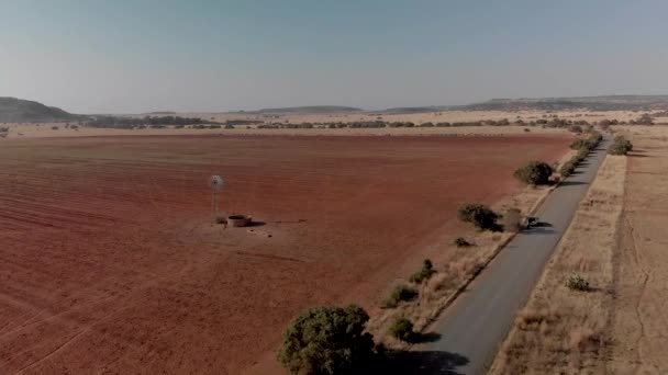 Aerial Fly Working Windpump Dry Field Gravel Road — Stockvideo