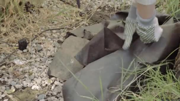 Woman Removing Tarpaulin Sheet Covering Ground Garden — Stockvideo