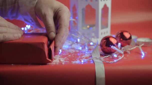 Wrapping Christmas Gift Ribbons Red Paper Red Background Baubles — Vídeo de Stock