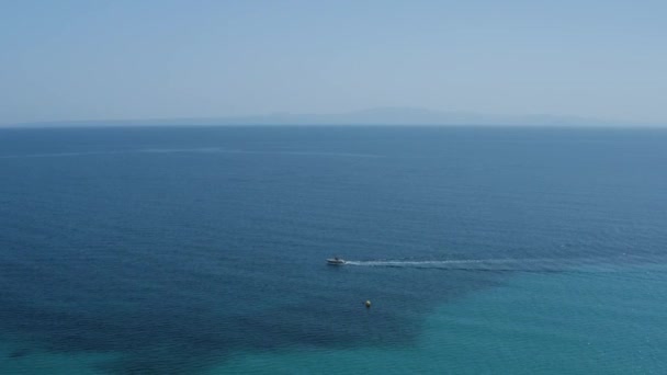 Aerial Drone Shot Backwards Boat Jet Ski Clear Blue Sea — Vídeos de Stock