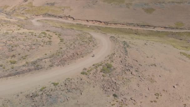 Aerial Shot Mountain Biker Climbing Pass Gravel Road — Stockvideo