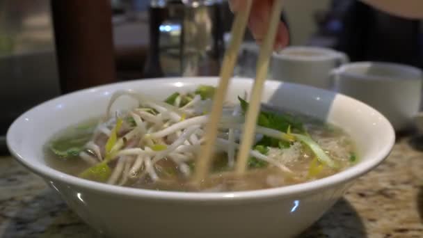 Someone Mixing Ingredients Vietnamese Soup Makes Action Chinese Sticks — Stock video