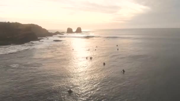 Aerial Drone Shot Sea Golden Hour Flying Surfers Giant Rocks — Stockvideo