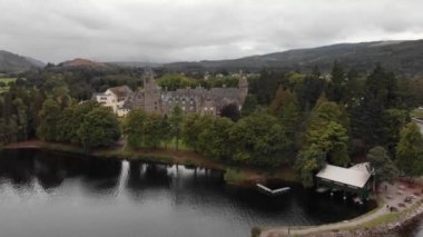 Slow pan over Loch Ness viewing Fort Augustus Abbey, aerial