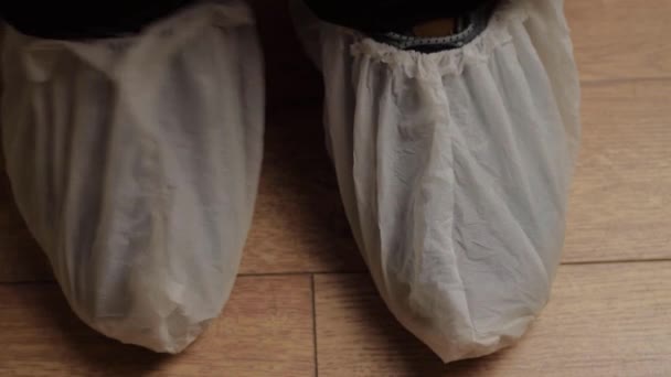 Pair Feet Wearing Disposable Shoe Protectors — Video Stock