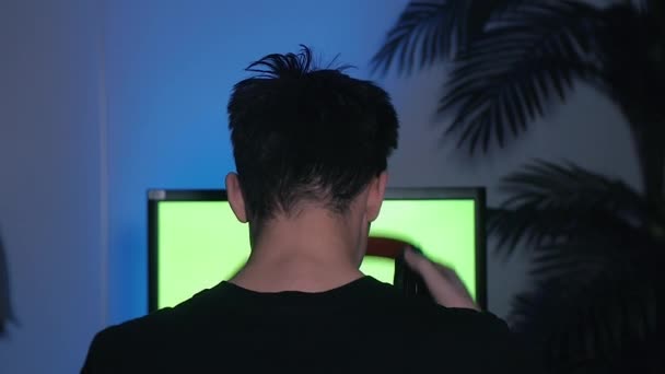 Gamer Puts His Headset Mic Starts Playing Computer Games Green — Vídeo de Stock