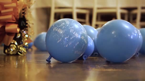 Blue Balloons Boy Printed Them Rolling Floor Close — Vídeos de Stock